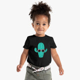 Child wearing a black t-shirt with a cactus design, standing against a white background