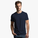 A man wearing a navy blue crew neck t-shirt.