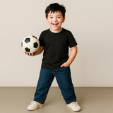 Child holding a soccer ball against a plain background