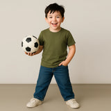 Child holding a soccer ball against a plain background