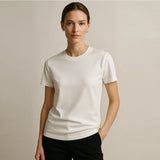 Woman wearing a plain white t-shirt against a neutral background